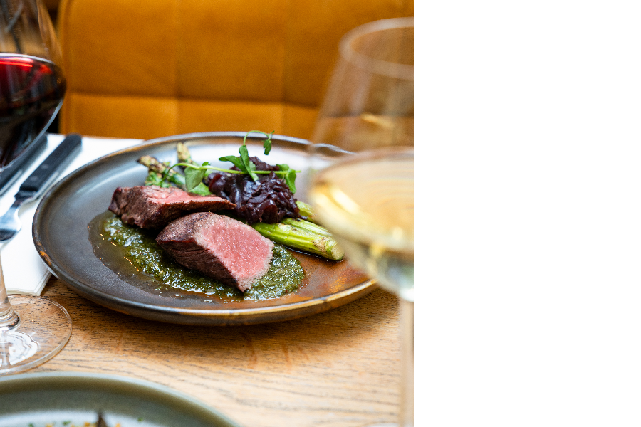 Flank steak with chimichurri, red onion compote, and green asparagus